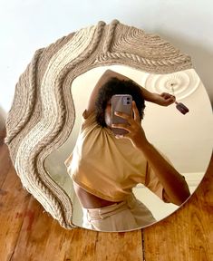 a woman taking a selfie in front of a mirror