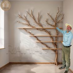 a man standing in front of a tree made out of wooden branches with his hands on it