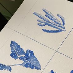 some blue and white tiles with leaves on them