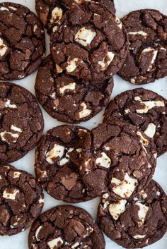 chocolate cookies with marshmallows are on a plate