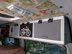 the inside of an rv with bicycles on the ceiling