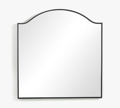 a mirror that is on the wall with a black frame and an oval shape around it