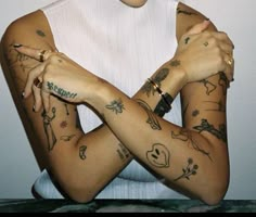 a woman with many tattoos on her arms