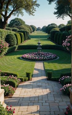 a garden with lots of green grass and flowers in the center, surrounded by hedges