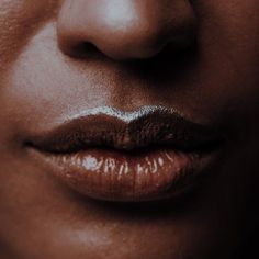 a woman's lips and nose are shown in this close up photo, with the light reflecting off her face