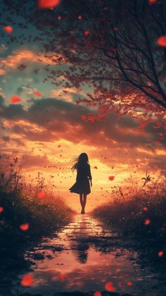 a girl is walking down a path in the sunset