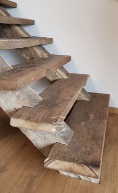 a wooden christmas tree sitting on top of a hard wood floor