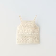 a cropped tank top with crochet on the front