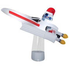 a toy airplane that is sitting on top of a glass stand with an object in the shape of a rocket ship