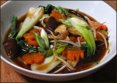 a white bowl filled with soup and vegetables