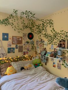 a bedroom with plants growing on the wall and pictures hanging above the bedspread