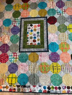 a quilted table runner with an appliqued square on it's center