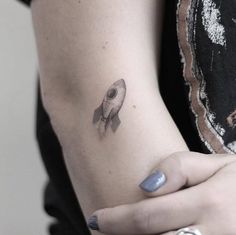 a woman with a small tattoo on her arm