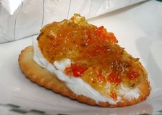 a piece of food sitting on top of a white plate next to a plastic bag