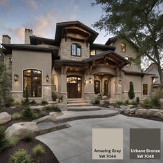 an exterior view of a large home with stone and stucco work on the front porch