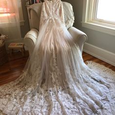 a wedding dress is sitting on top of a chair