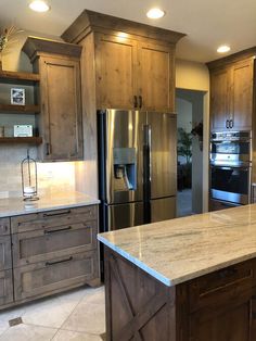 a kitchen with granite counter tops and stainless steel appliances