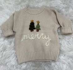 a sweater with two small trees on it