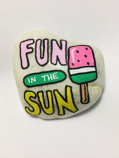 a rock that says fun in the sun with an ice cream on top and a popsicle