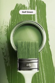 a paint can with a brush in it's mouth on a green painted wall