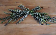 some green plants are on a wooden surface