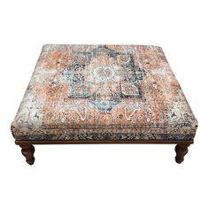 an orange and blue ottoman with ornate designs