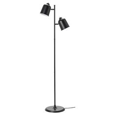 a floor lamp with two black lamps on it