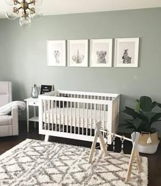 a baby's room with gray walls and white furniture