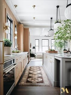 a kitchen with wooden cabinets and white walls, along with a rug on the floor