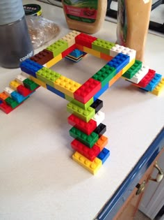 a table topped with lots of legos on top of a white kitchen countertop