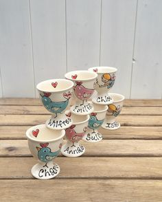 a stack of cups with birds painted on them