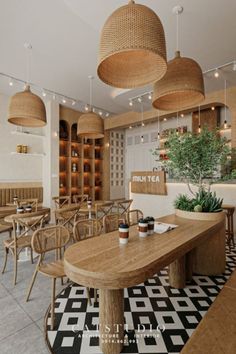 the interior of a restaurant with wooden tables, chairs and potted plants hanging from the ceiling