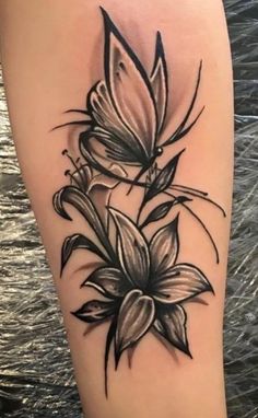 a black and white flower tattoo on the leg