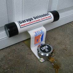 a pair of keys is attached to a garage door with the word garage defender on it