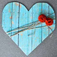 a wooden heart with some strings attached to it and a small figurine holding a guitar