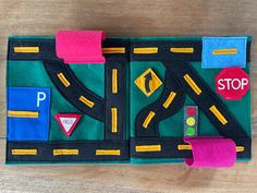 a felt play mat with road and stop signs on it