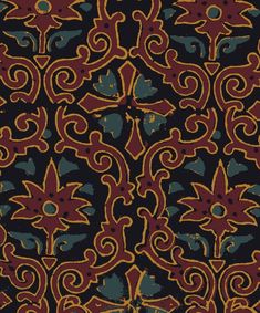 an intricately designed fabric with gold and blue accents on black background, closeup