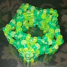 green and yellow bracelets are sitting on a table