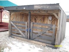 an outhouse with two doors and a ramp