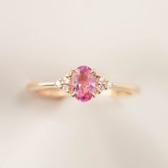 * ≈6x4mm Pink tourmaline * Side stones : White diamonds G color SI1 0.06ctw * Band width: ≈1.4mm Tapered band * 14k solid rose gold * Made of 100% recycled solid14k gold metal and ethically sourced gemstones Ring Size This ring is currently size 7, and can be resized 3~8.5 in 10 days. For other ring size, it is going to be a custom order. Please email cs@enverojewelry.com. Custom Order This ring can be made in any size, any material and different gemstone. For full details of semi-custom order, Diamond Ring Oval, Pink Engagement Ring, Outfit Polyvore, Dainty Engagement Rings, Pink Diamond Ring, 27 Dresses, Sapphire Earrings Studs, Pink Tourmaline Ring, Unique Engagement Ring