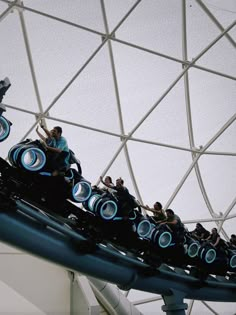 People sitting on a rollercoaster Tron Lightcycle Run in Magic Kingdom at Walt Disney World in Orlando Florida Tron Magic Kingdom, Tron Disney World, Tomorrowland Aesthetic, Disney World Tomorrowland, Wdw Aesthetic, Disneyworld Aesthetic, Disney Passholder, Disney World Attractions, Disneyland World