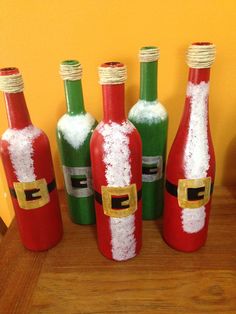 four bottles with santa claus's on them sitting on a table next to each other