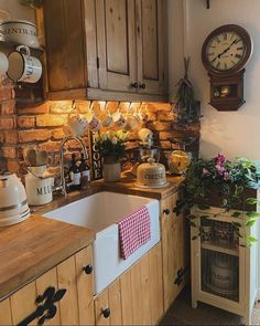 a kitchen with wooden cabinets and a clock on the wall above the sink is decorated with flowers