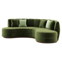 a large green couch with pillows on it's back and two round ottomans in the middle