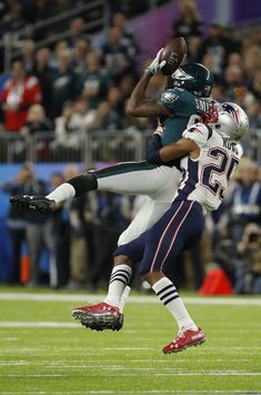 two football players in the air during a game