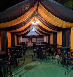 a large tent set up with tables and chairs