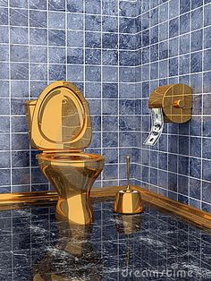 a bathroom with blue tiled walls and gold toilet in the middle, next to a roll of toilet paper