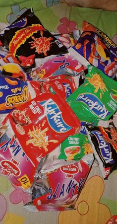 a pile of candy sitting on top of a bed