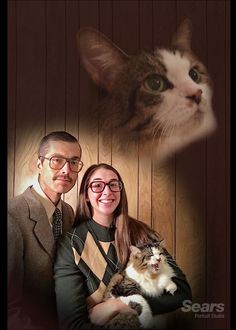 a man and woman pose for a photo with a cat in front of their face