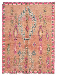 an antique rug with pink and blue accents